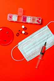syringe and pills with petri dish